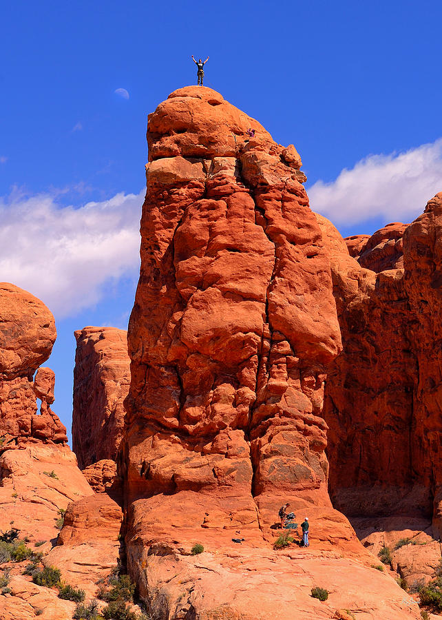Rock climber reaches the top in Arches National Park